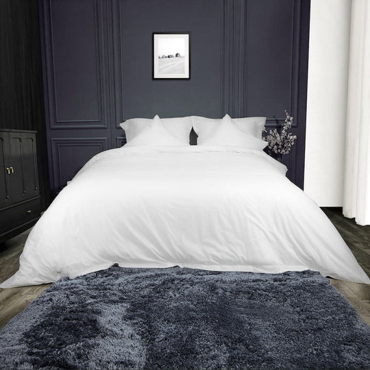 white bedsheet with cushions and pillows