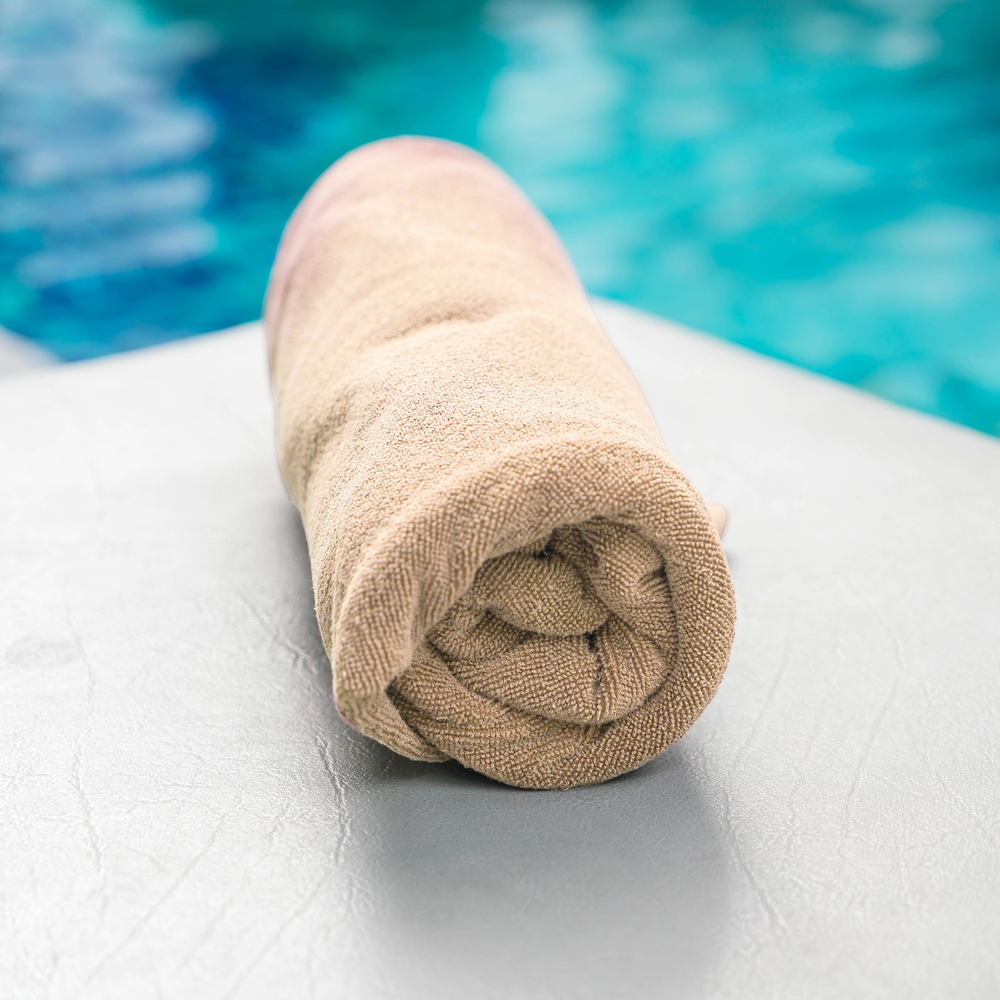 Beige Folded Beach Towel on chair