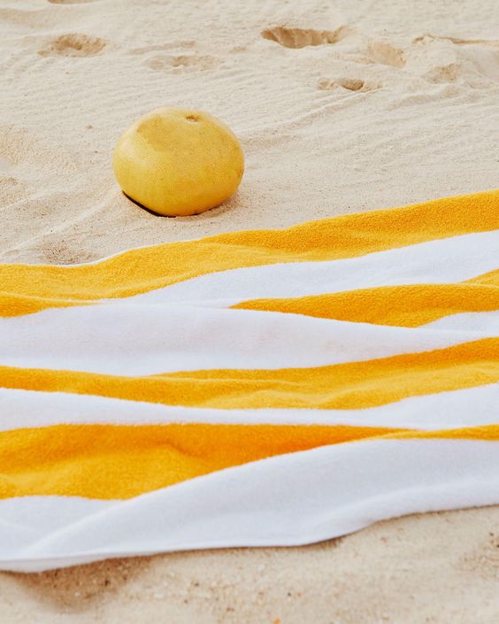 striped towel on sand 