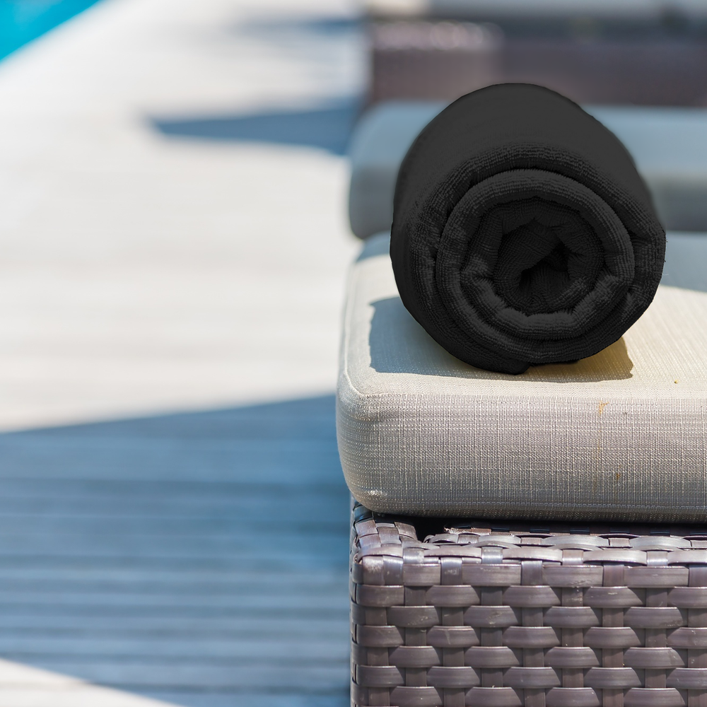 Black Folded Beach Towel on Table